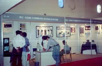Su-Kam Communication System exhibition booth showing CATV amplifiers and directional couplers