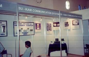 Su-Kam Communication System booth with outdoor amplifiers and directional couplers on display
