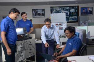 Kunwer Sachdev with R&D engineers discussing inverter design
