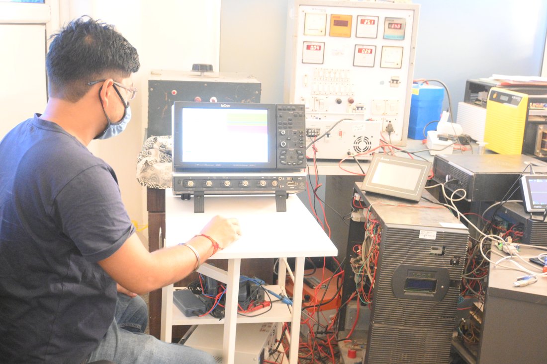 A Su-Kam engineer testing an inverter on an oscilloscope in the R&D lab