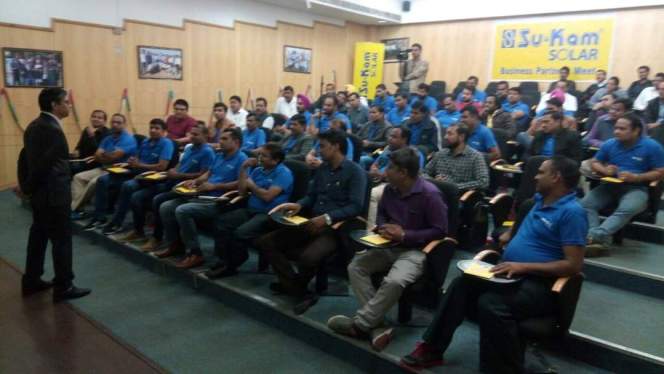 Su-Kam Solar business partner meet — dealers in blue, brand on the wall