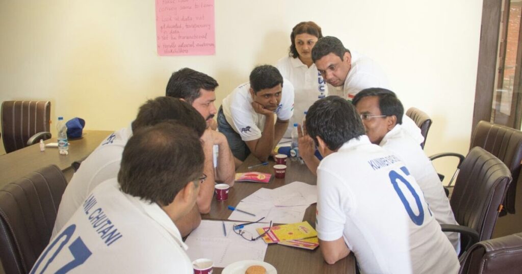 Kunwer Sachdev discussing ISO 9001 quality standards with Su-Kam employees in a quality management meeting