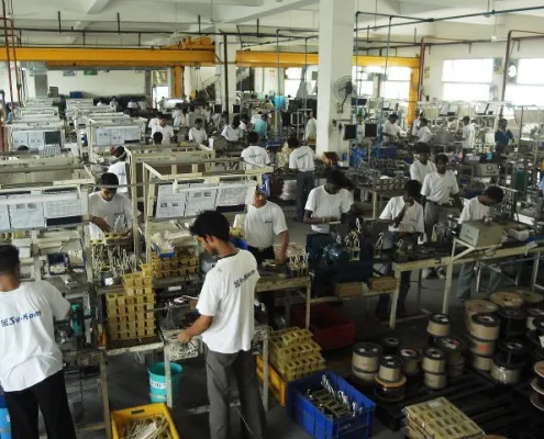 Su-Kam manufacturing assembly line with workers on the factory floor