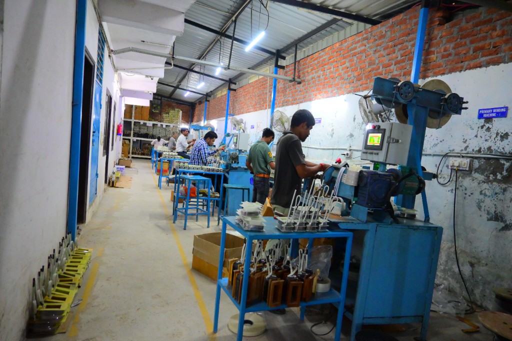 Technicians at primary winding machines on an Indian manufacturing production line
