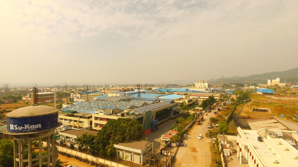 Aerial view of Su-Kam industrial campus with branded water tower and factory buildings