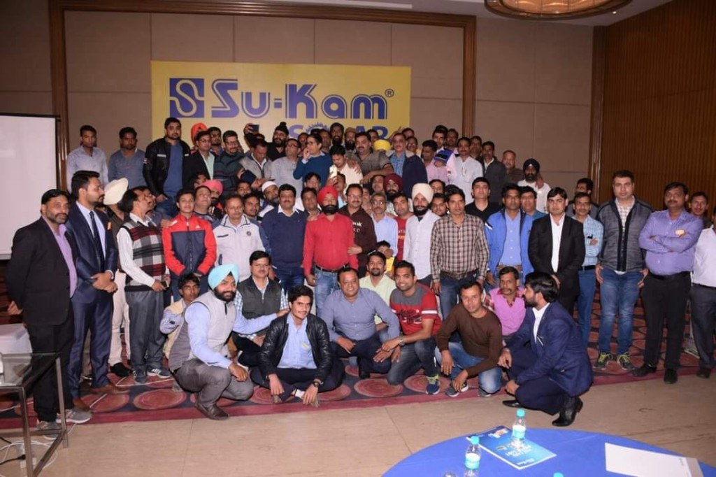 Su-Kam Solar team gathered under the company banner — the people behind the manufacturing and patents
