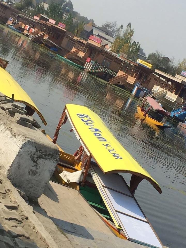Kashmiri shikara with Su-Kam Solar canopy and solar panels mounted under the roof on Dal Lake