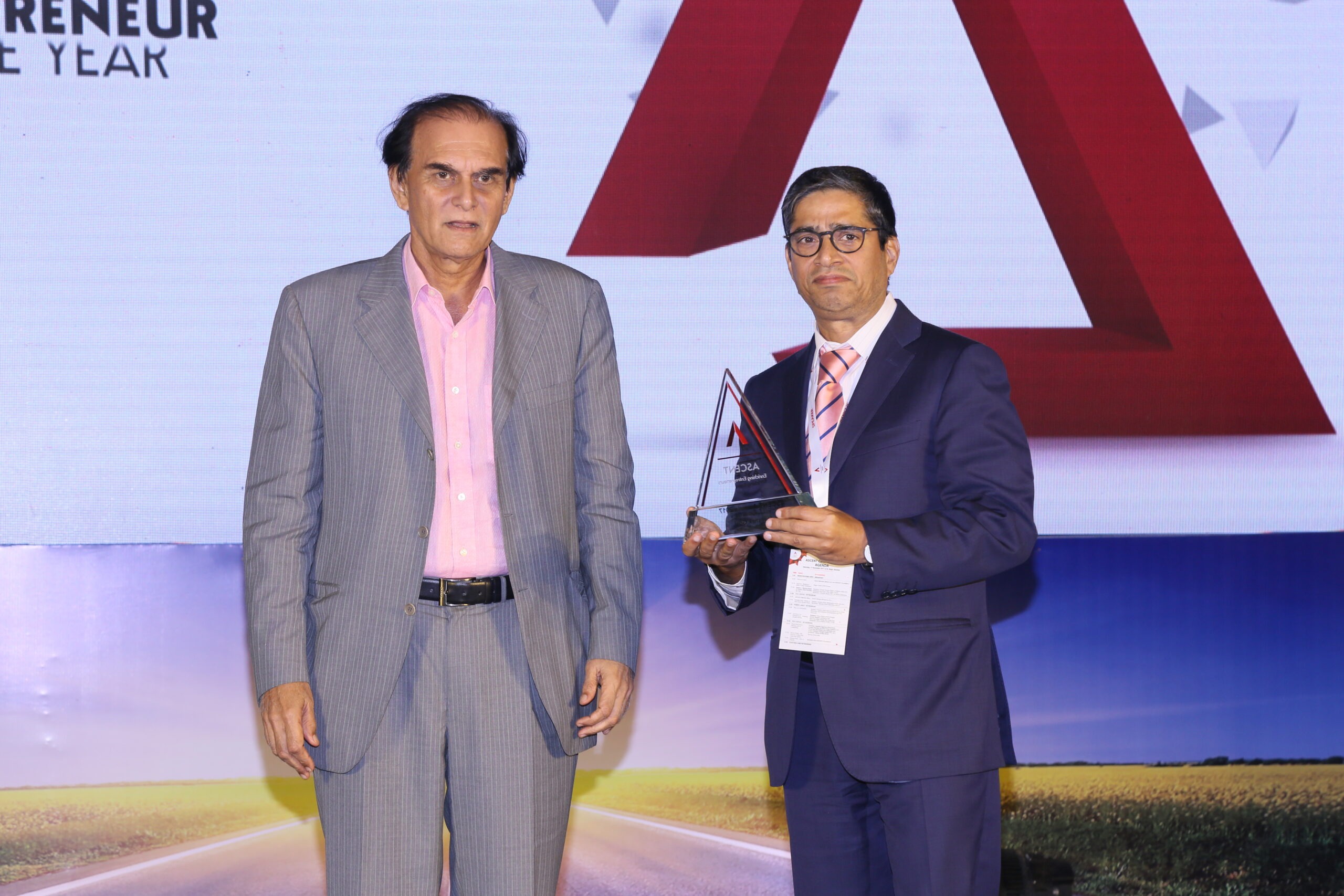 Kunwer Sachdev receiving Entrepreneur of the Year ASCENT award trophy