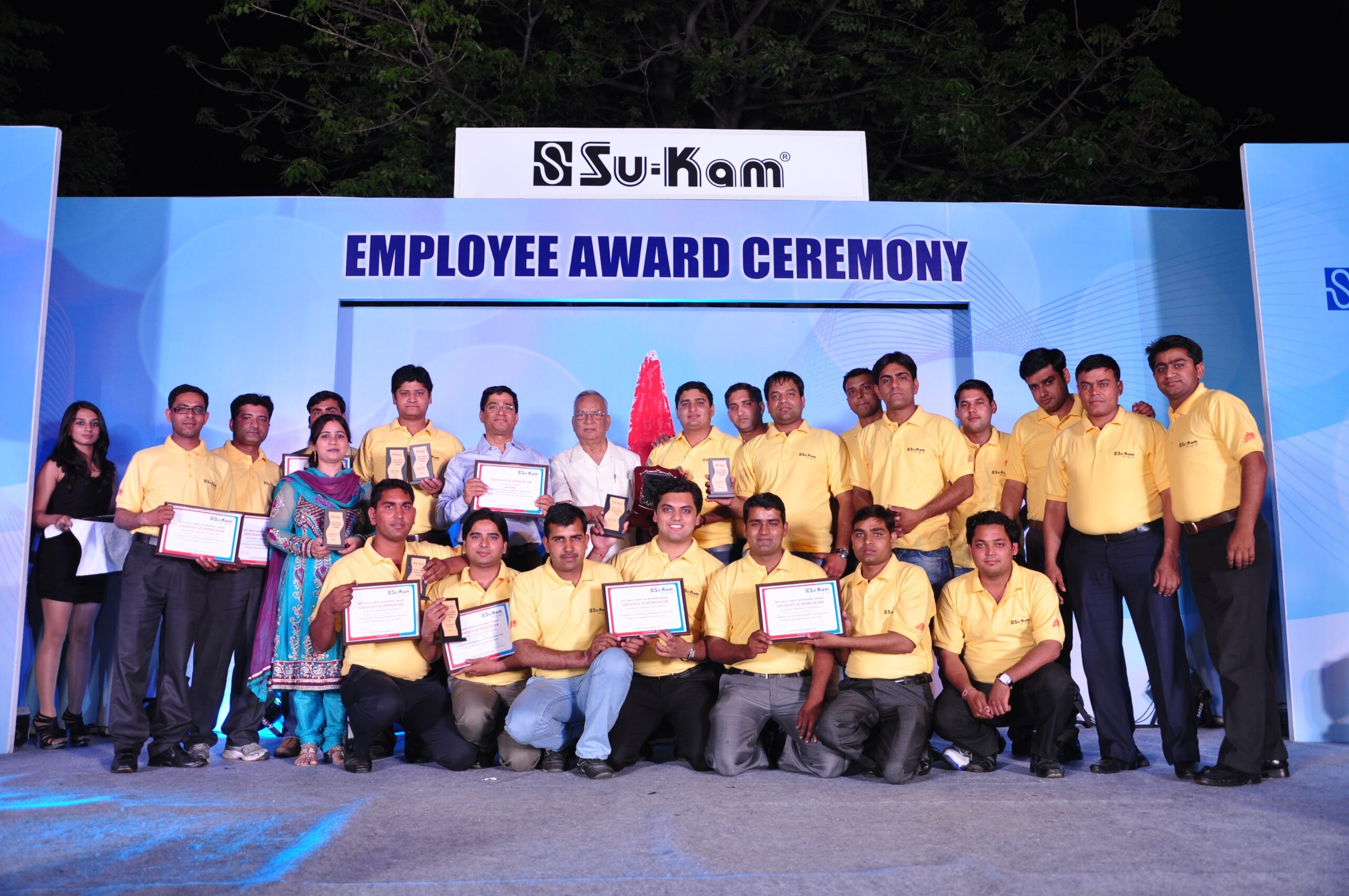 Su-Kam employees posing with certificates and trophies at Employee Award Ceremony