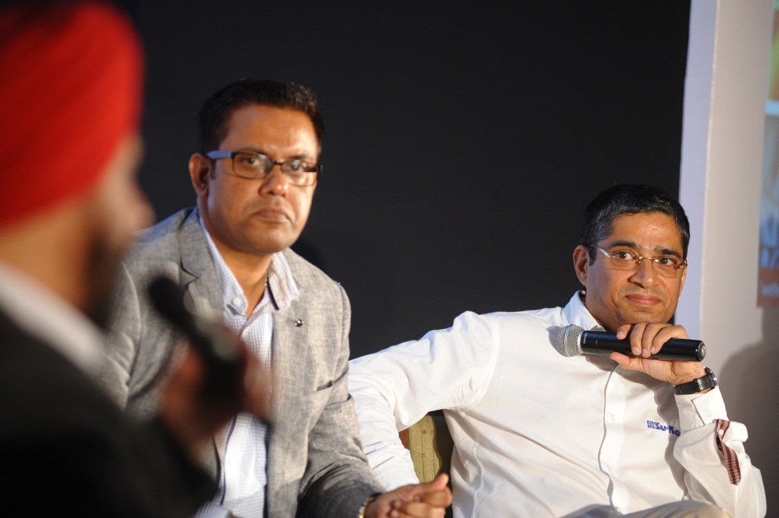 Kunwer Sachdev on stage with microphone